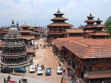 Kathmandu Patan Durbar Square 02 Krishna Temple, Taleju Bell, Hari Shankar Temple And Royal Palace The octagonal white stone Krishna Temple sits on the west side of Patans Durbar Square, while the whole eastern side is occupied by the Royal Palace. This view from the south was taken from the Teleju Restaurant.